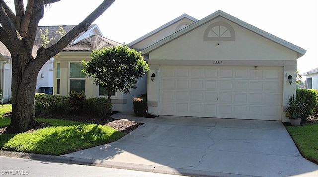 25561 Fairway Dunes Ct, Bonita Springs, FL 34135 - view of front of house with stucco siding, driveway, and an attached garage