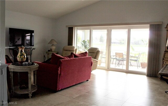 25561 Fairway Dunes Ct, Bonita Springs, FL 34135 - living area featuring lofted ceiling, healthy amount of natural light, and light tile patterned floors