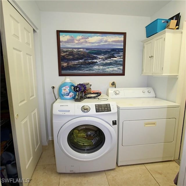 25561 Fairway Dunes Ct, Bonita Springs, FL 34135 - washroom featuring washer and dryer, cabinet space, and light tile patterned floors
