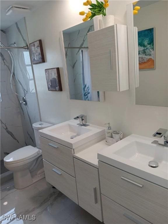 2244 Parkview Dr, Fort Myers, FL 33905 - bathroom with a marble finish shower, vanity, marble finish flooring, and toilet