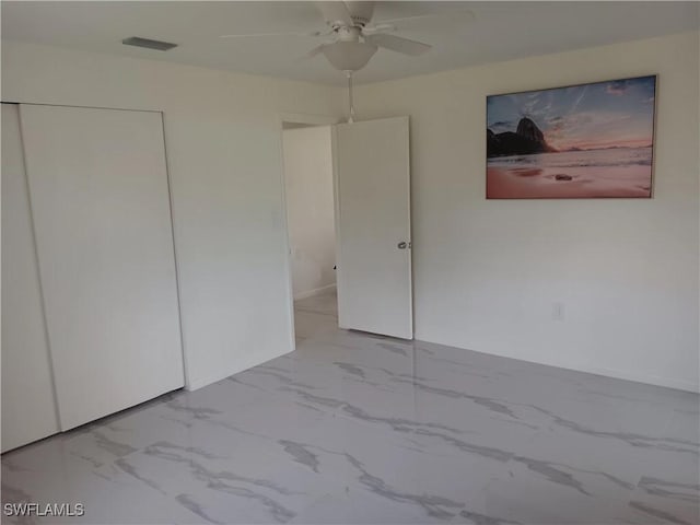 2244 Parkview Dr, Fort Myers, FL 33905 - unfurnished bedroom with marble finish floors, a closet, and a ceiling fan