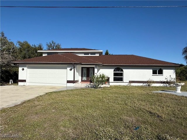 1438 Navigator Rd, Punta Gorda, FL 33983 - view of front of home with stucco siding, driveway, a garage, a front lawn, and french doors