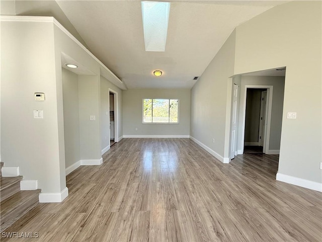 1438 Navigator Rd, Punta Gorda, FL 33983 - unfurnished room featuring lofted ceiling, light wood-style flooring, baseboards, and stairs