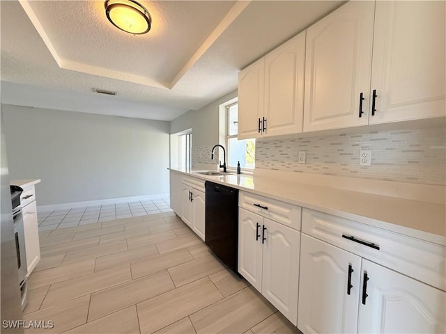 1438 Navigator Rd, Punta Gorda, FL 33983 - kitchen featuring dishwasher, a raised ceiling, a sink, decorative backsplash, and white cabinets