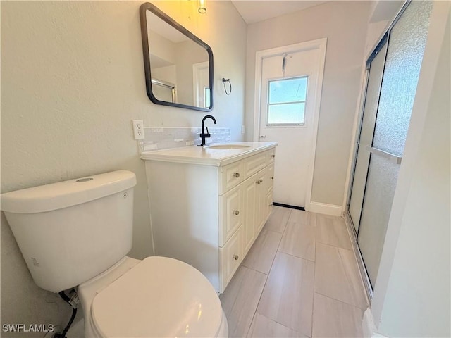 1438 Navigator Rd, Punta Gorda, FL 33983 - full bathroom with toilet, vanity, a shower with door, tasteful backsplash, and tile patterned flooring