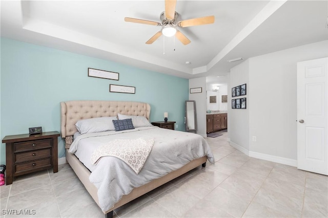 14121 Roof St, Fort Myers, FL 33905 - bedroom featuring a tray ceiling, light tile patterned flooring, baseboards, and ensuite bath