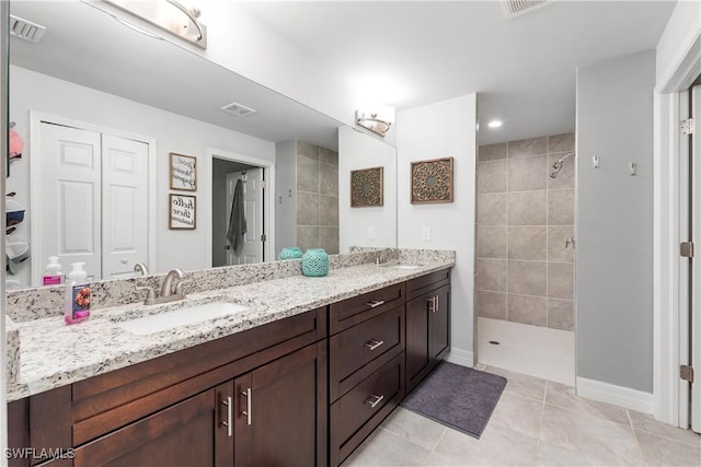 14121 Roof St, Fort Myers, FL 33905 - bathroom featuring walk in shower, double vanity, tile patterned flooring, a closet, and baseboards