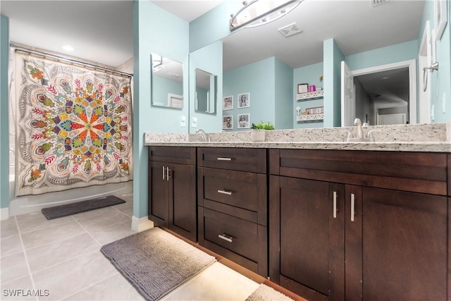 14121 Roof St, Fort Myers, FL 33905 - bathroom with double vanity, tile patterned flooring, and baseboards