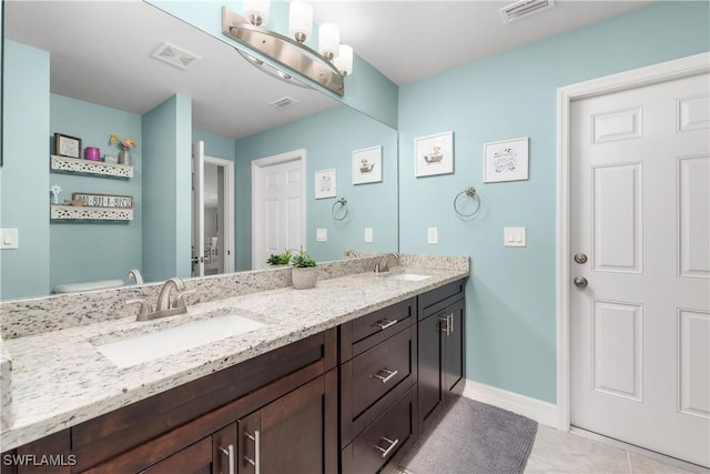 14121 Roof St, Fort Myers, FL 33905 - bathroom with double vanity, toilet, tile patterned floors, and baseboards