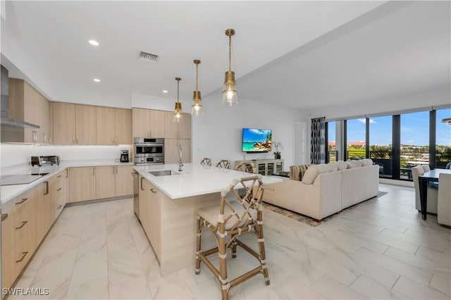 1115 Central Ave Unit 547, Naples, FL 34102 - kitchen featuring light brown cabinets, a sink, light marble finish flooring, modern cabinets, and black electric cooktop