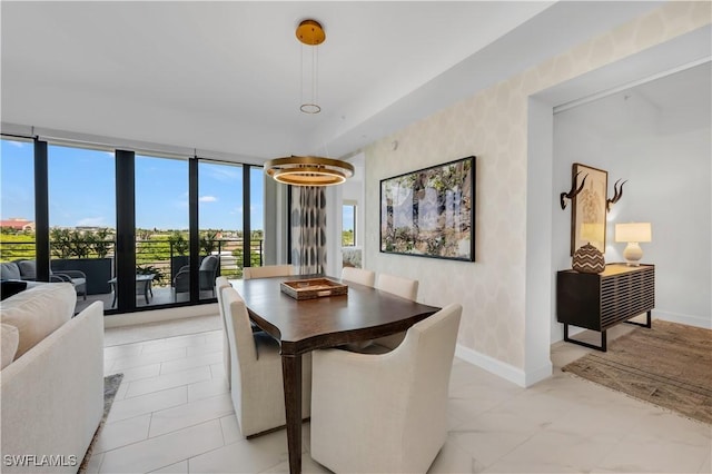 1115 Central Ave Unit 547, Naples, FL 34102 - dining room featuring wallpapered walls, baseboards, and floor to ceiling windows