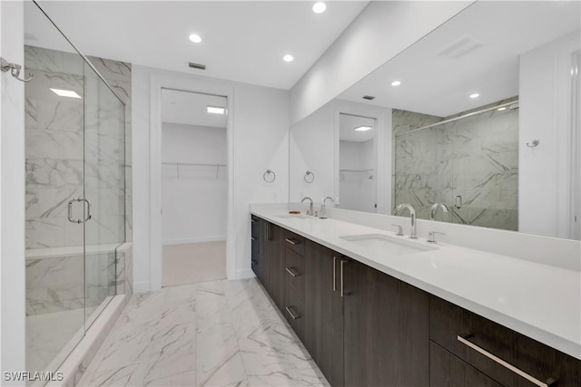 1115 Central Ave Unit 547, Naples, FL 34102 - bathroom featuring a marble finish shower, marble look tile flooring, recessed lighting, double vanity, and a spacious closet
