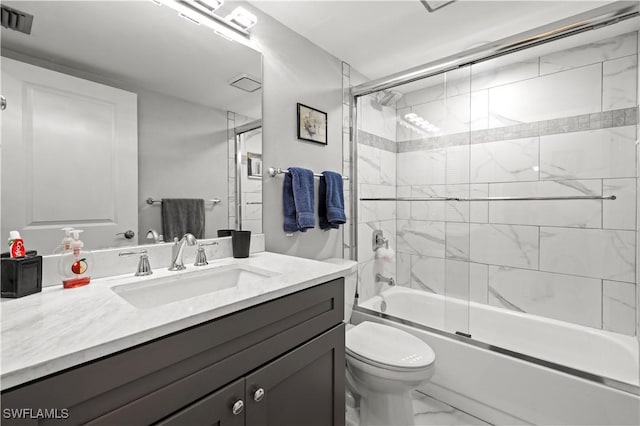 17451 Overhill Dr Unit F, Fort Myers, FL 33908 - bathroom with marble look tile flooring, vanity, toilet, and combined bath / shower with glass door