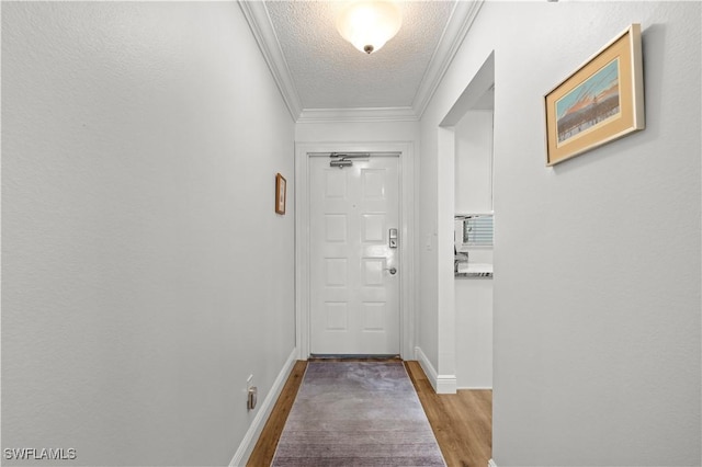 17451 Overhill Dr Unit F, Fort Myers, FL 33908 - doorway to outside with a textured ceiling, wood finished floors, crown molding, and baseboards