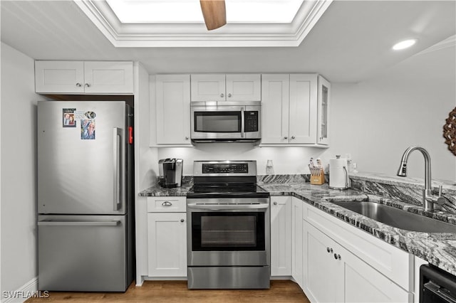 17451 Overhill Dr Unit F, Fort Myers, FL 33908 - kitchen featuring appliances with stainless steel finishes, a sink, white cabinetry, light wood-style floors, and recessed lighting