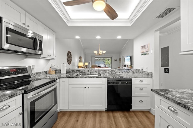 17451 Overhill Dr Unit F, Fort Myers, FL 33908 - kitchen with appliances with stainless steel finishes, a sink, light wood-style flooring, white cabinetry, and ornamental molding