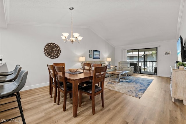 17451 Overhill Dr Unit F, Fort Myers, FL 33908 - dining area with a chandelier, light wood-style flooring, baseboards, ornamental molding, and lofted ceiling