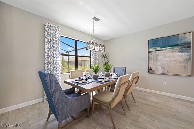4513 NW 35th Ave, Cape Coral, FL 33993 - dining space with a chandelier and baseboards