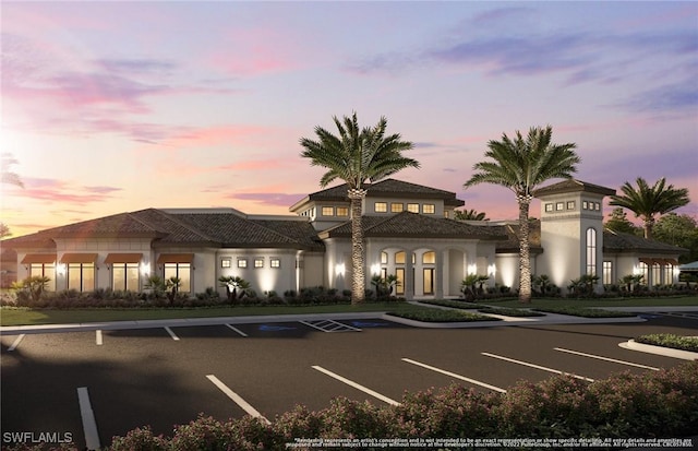 1825 Verada Ct, Naples, FL 34120 - property at dusk with uncovered parking