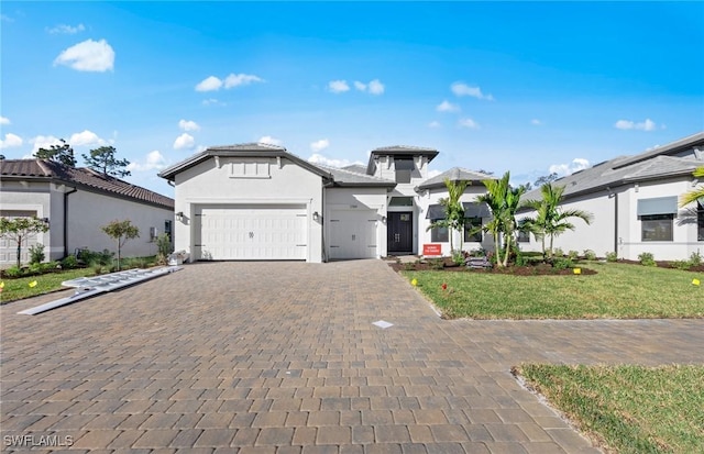 1825 Verada Ct, Naples, FL 34120 - view of front of house with an attached garage, decorative driveway, stucco siding, and a front lawn
