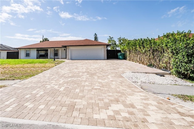4924 20th Pl SW, Naples, FL 34116 - view of front of home with decorative driveway, a garage, and a front yard