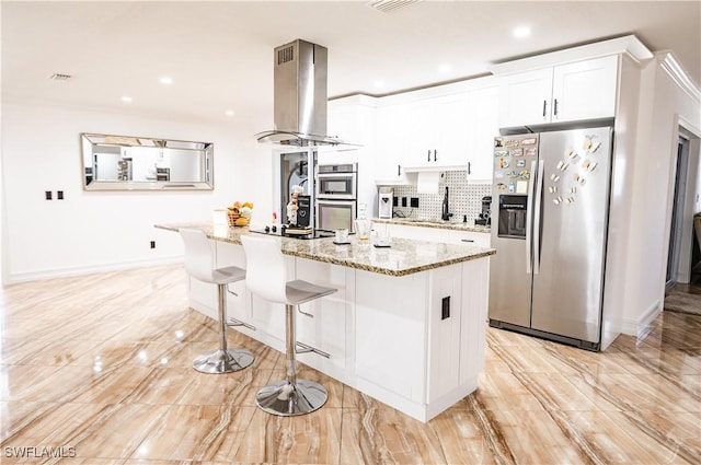 4924 20th Pl SW, Naples, FL 34116 - kitchen with stainless steel appliances, island exhaust hood, white cabinetry, baseboards, and light stone counters