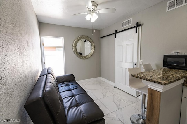 4924 20th Pl SW, Naples, FL 34116 - living area featuring a barn door, ceiling fan, and light marble finish flooring