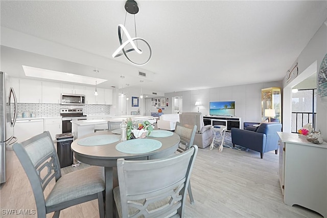 2 Pirates Ln Unit 24B, Punta Gorda, FL 33955 - dining space featuring light wood-type flooring