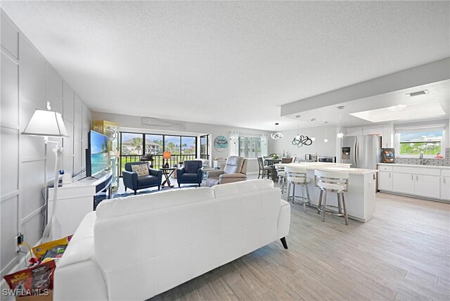 2 Pirates Ln Unit 24B, Punta Gorda, FL 33955 - living room with light wood finished floors and a textured ceiling