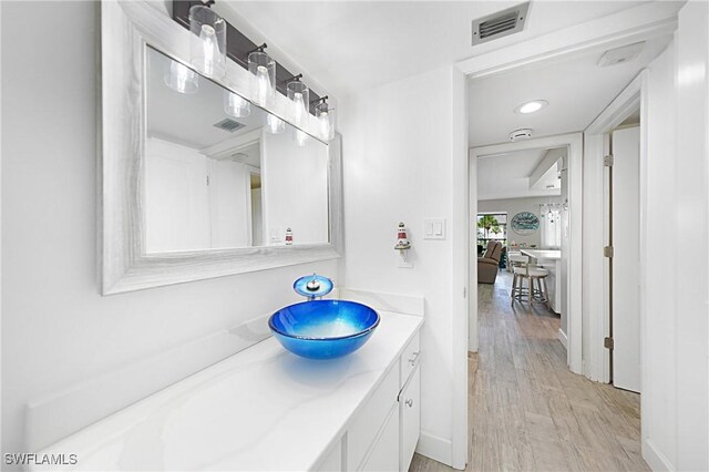 2 Pirates Ln Unit 24B, Punta Gorda, FL 33955 - bathroom featuring wood finished floors, vanity, and recessed lighting