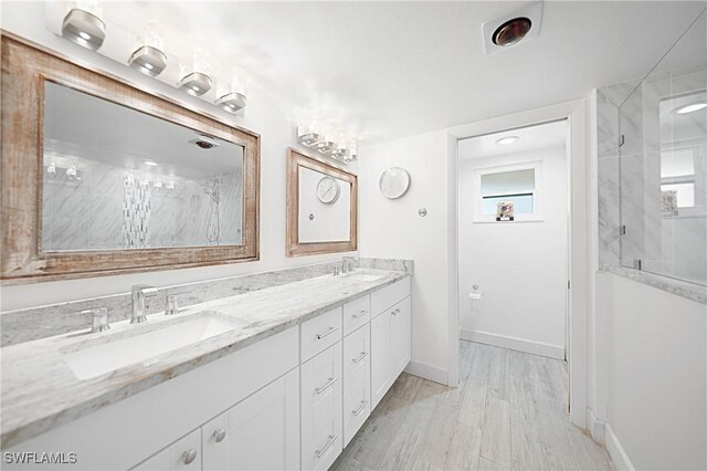 2 Pirates Ln Unit 24B, Punta Gorda, FL 33955 - full bathroom with double vanity, a marble finish shower, wood finished floors, and healthy amount of natural light