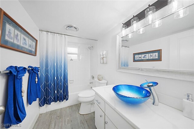 2 Pirates Ln Unit 24B, Punta Gorda, FL 33955 - full bath with vanity, wood finished floors, shower / tub combo, and toilet