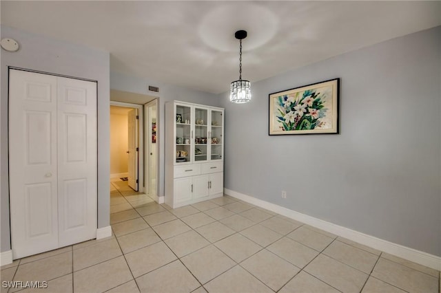 1464 Park Shore Cir Unit 2, Fort Myers, FL 33901 - unfurnished dining area with light tile patterned flooring, baseboards, and a chandelier