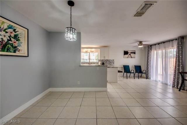 1464 Park Shore Cir Unit 2, Fort Myers, FL 33901 - unfurnished room featuring a ceiling fan, baseboards, light tile patterned floors, and a chandelier