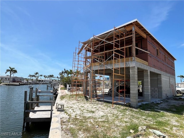 99 Blackbeard Way, Fort Myers Beach, FL 33931 - dock area with a water view and a patio area