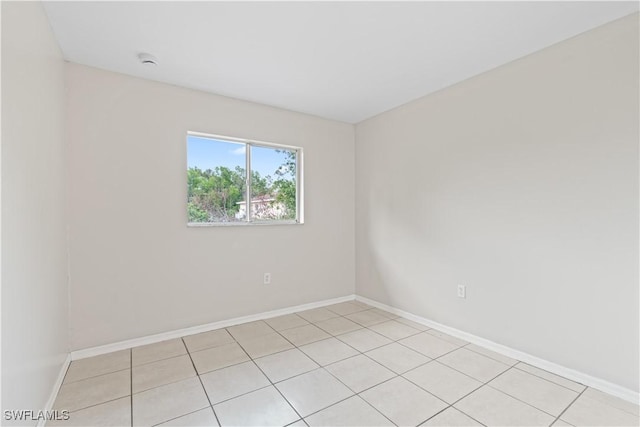 209 Meadow Rd, Lehigh Acres, FL 33973 - spare room with a smoke detector, baseboards, and light tile patterned floors