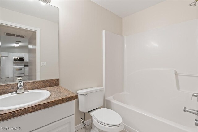 209 Meadow Rd, Lehigh Acres, FL 33973 - bathroom featuring vanity, toilet, shower / washtub combination, and baseboards