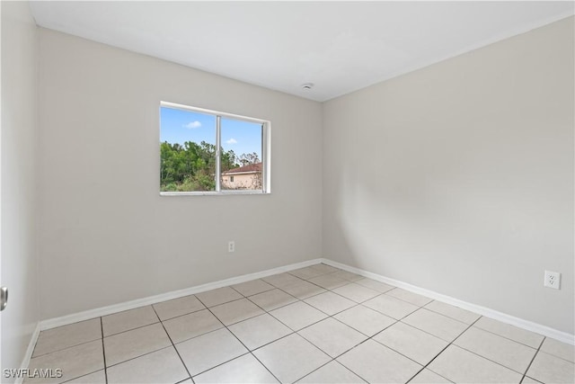 209 Meadow Rd, Lehigh Acres, FL 33973 - empty room featuring baseboards and light tile patterned floors