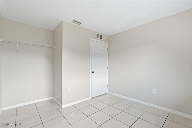 209 Meadow Rd, Lehigh Acres, FL 33973 - unfurnished bedroom with baseboards, a closet, and light tile patterned flooring