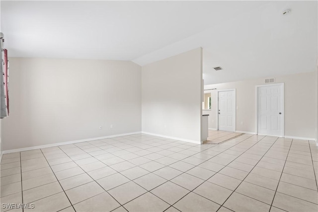 209 Meadow Rd, Lehigh Acres, FL 33973 - empty room featuring light tile patterned floors, vaulted ceiling, and baseboards