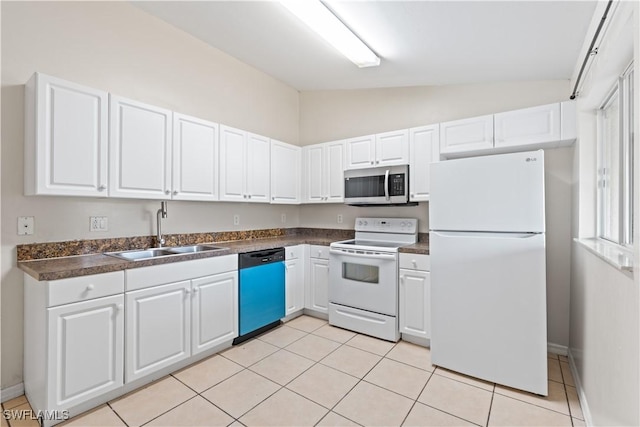 209 Meadow Rd, Lehigh Acres, FL 33973 - kitchen featuring white appliances, a sink, vaulted ceiling, dark countertops, and white cabinets