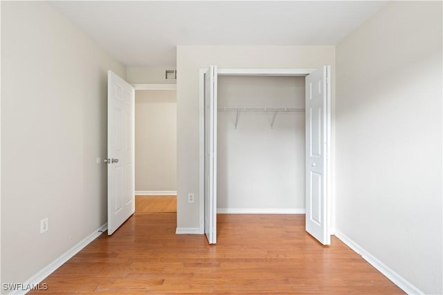 209 Meadow Rd, Lehigh Acres, FL 33973 - unfurnished bedroom with light wood finished floors, a closet, and baseboards