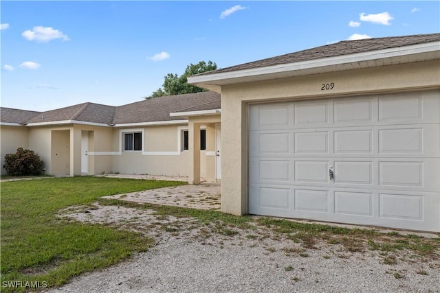 209 Meadow Rd, Lehigh Acres, FL 33973 - view of front facade with driveway, stucco siding, a front lawn, roof with shingles, and a garage