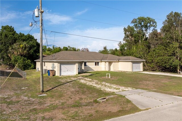 209 Meadow Rd, Lehigh Acres, FL 33973 - ranch-style home with dirt driveway, a garage, a front yard, and central AC