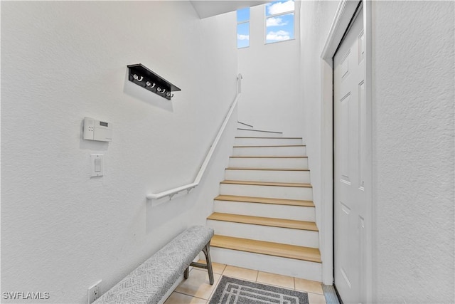 20051 Seagrove St Unit 1206, Estero, FL 33928 - stairway featuring a textured wall and tile patterned flooring