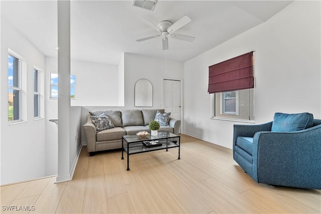 20051 Seagrove St Unit 1206, Estero, FL 33928 - living area featuring plenty of natural light, light wood finished floors, a ceiling fan, and baseboards