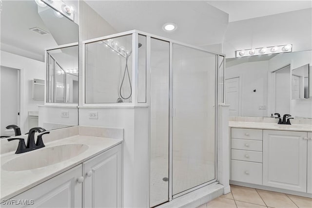 20051 Seagrove St Unit 1206, Estero, FL 33928 - bathroom featuring a shower stall, two vanities, tile patterned flooring, and recessed lighting