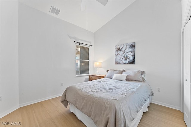 20051 Seagrove St Unit 1206, Estero, FL 33928 - bedroom with light wood-style flooring, baseboards, high vaulted ceiling, and ceiling fan