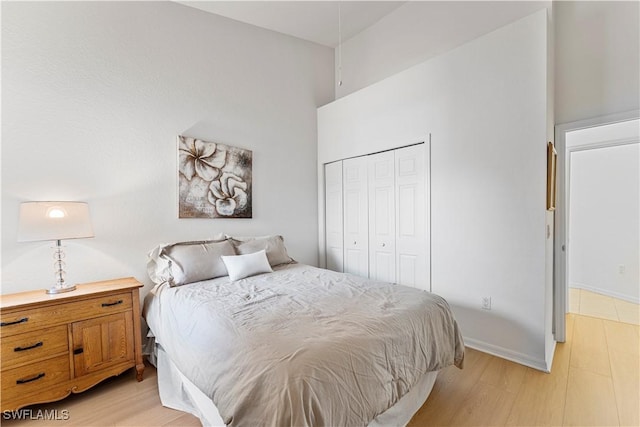 20051 Seagrove St Unit 1206, Estero, FL 33928 - bedroom with a closet, light wood-type flooring, and a high ceiling