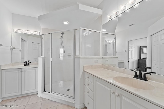 20051 Seagrove St Unit 1206, Estero, FL 33928 - bathroom featuring a stall shower, two vanities, and tile patterned flooring